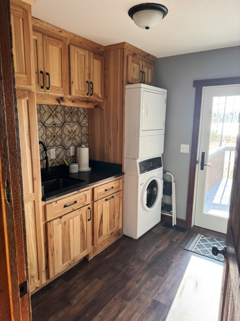 Laundry room with large utility sink and deck access.