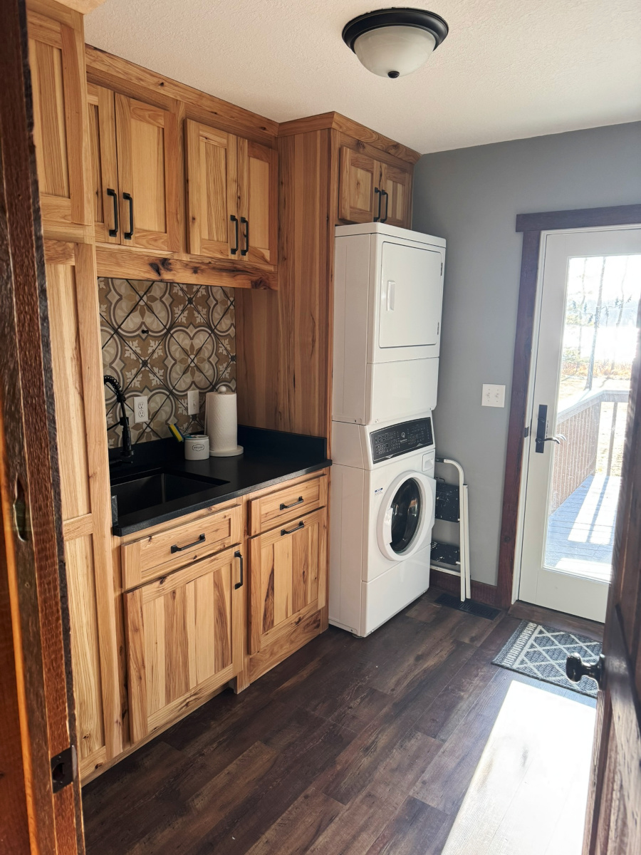 Laundry room with large utility sink and deck access.